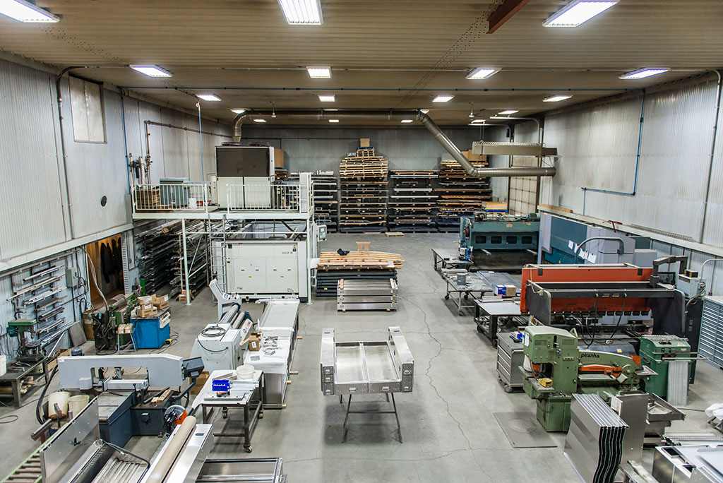 Perspective view of the shop floor at Upland Manufacturing show various metal working tools, supplies, and finished products (tool boxes, tool chests, side boxes).